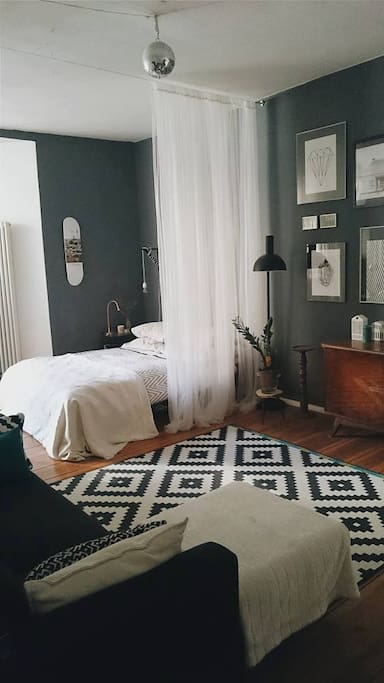 Bedroom with doors to the balcony on the left side