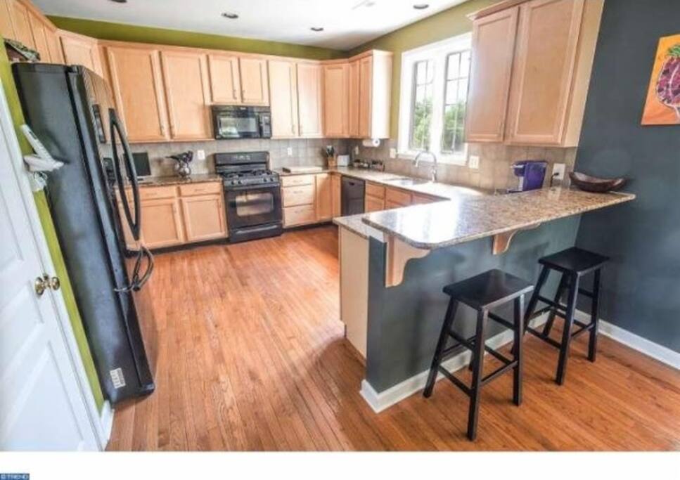 Large chef's kitchen with bar.