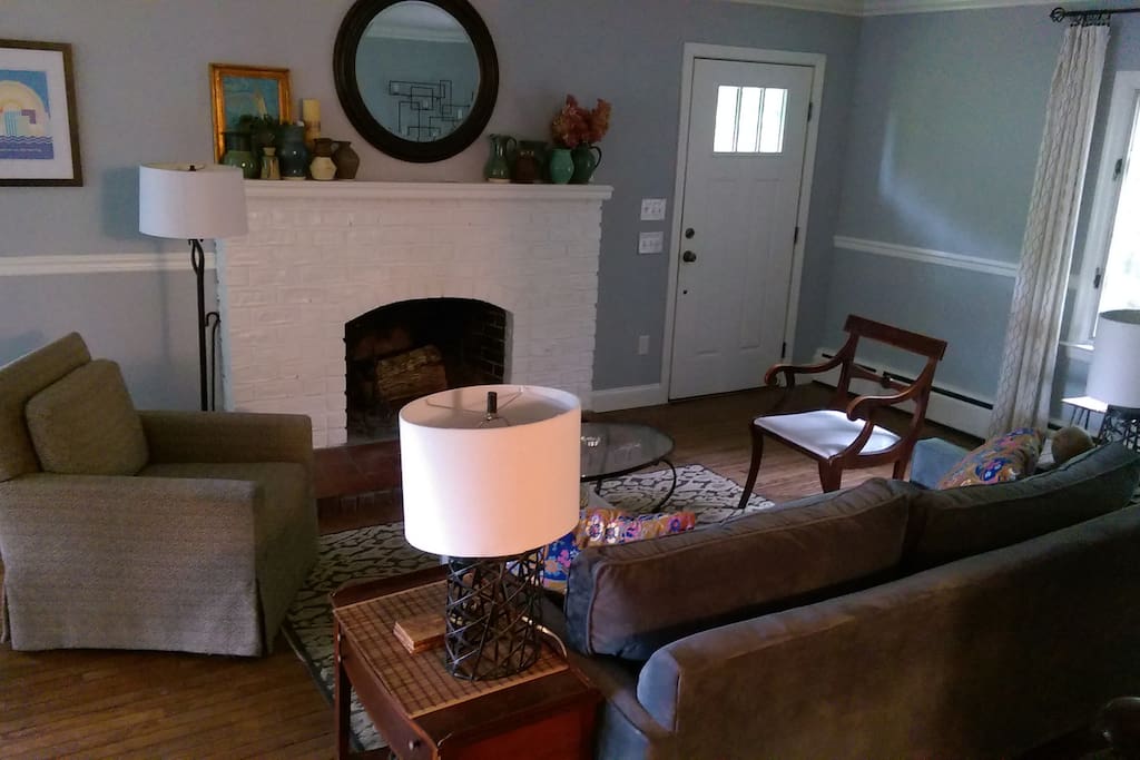 Living Room with queen size sofa bed and wood brining fireplace.
