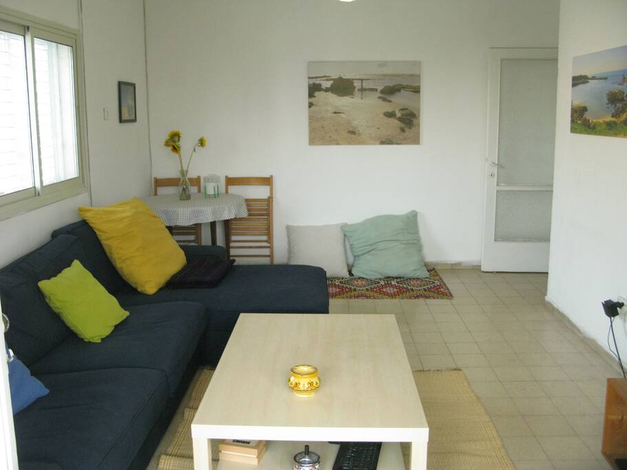 huge living room with large comfy sofas, tv, coffee table and dining table
