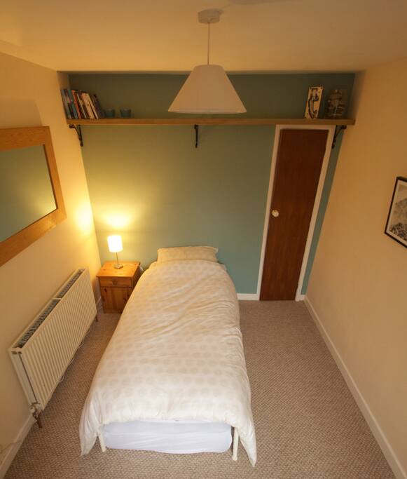 Bedroom with storage cupboard back right.