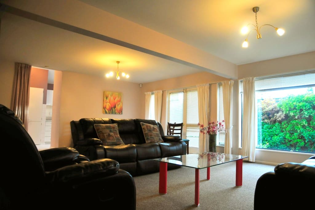 Lounge with comfy sofas, big TV, dining area, to outside area and kitchen