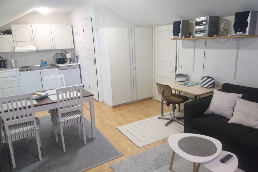 Kitchen contains refrigerator with small freezer box, dishwasher, stove, coffee maker, toaster, electric kettle and full dinner sets
