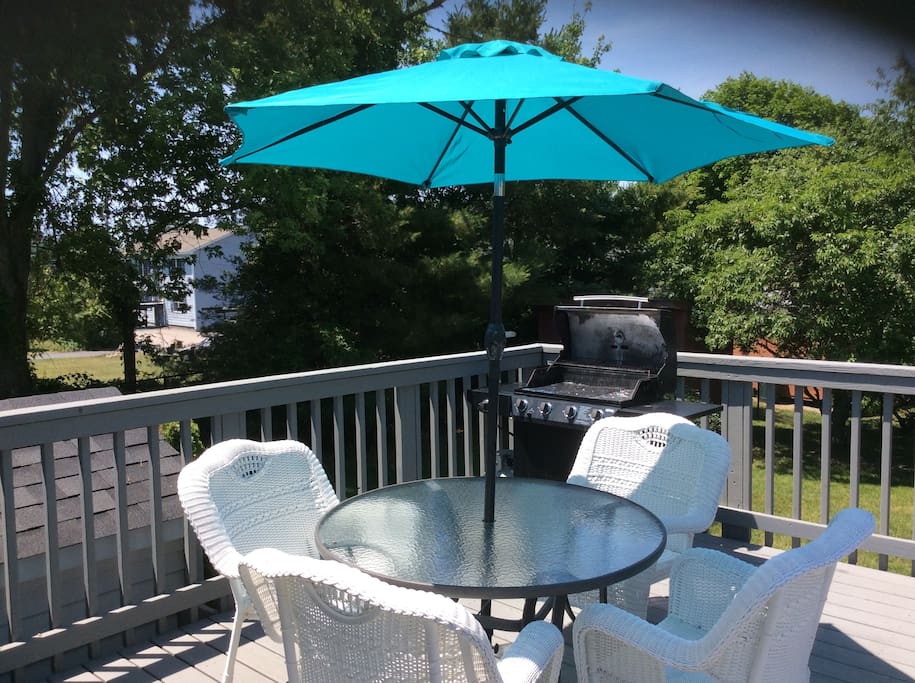 Back deck. Patio table with chairs and umbrella. Grill.