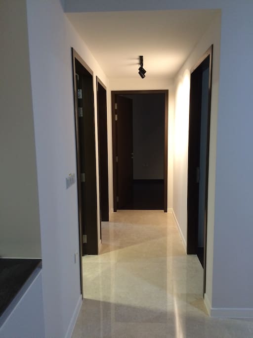 Walkway leading to the 3 bedrooms and common bathroom.