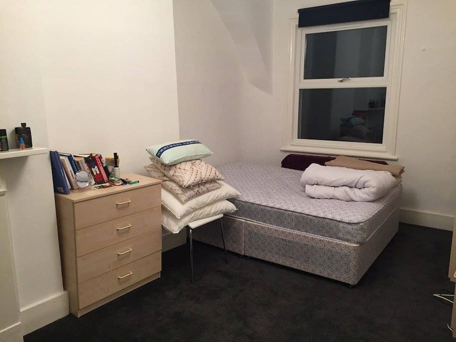 smaller bedroom, with a doublebed, a sofa, 2 wardrobes and a closet