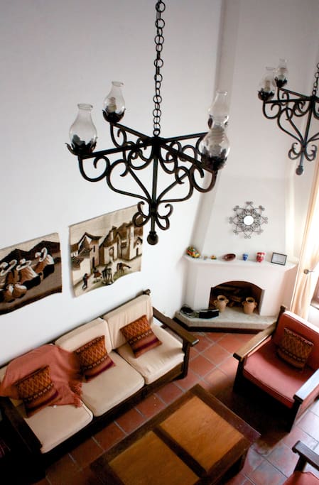 Living room with chimney and high ceilings