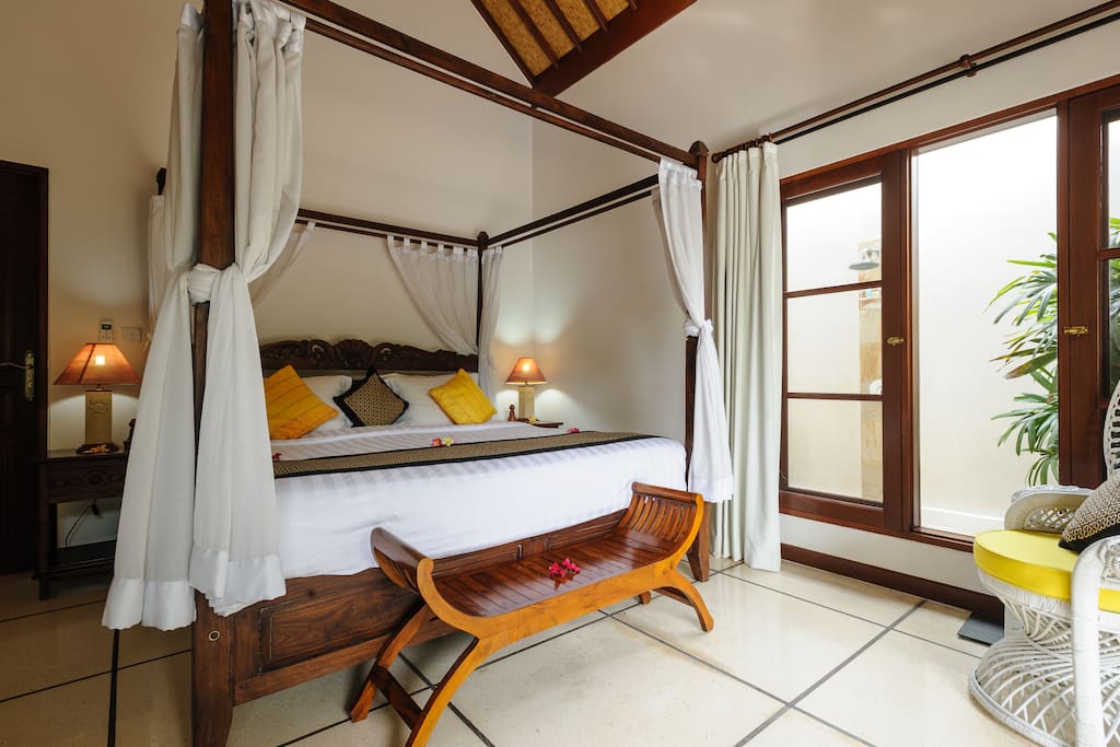 King Bedroom. This bedroom features a spacious ensuite (with indoor shower & bath), outdoor shower, a beautiful traditional balinese ceiling with fans & A/C to keep you cool on those warm Bali nights. This bedroom is definitely fit for royalty!