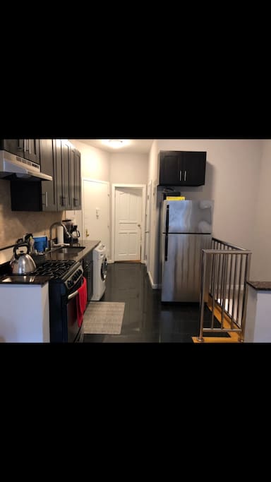 Open Kitchen with Dishwasher and Laundry machine.