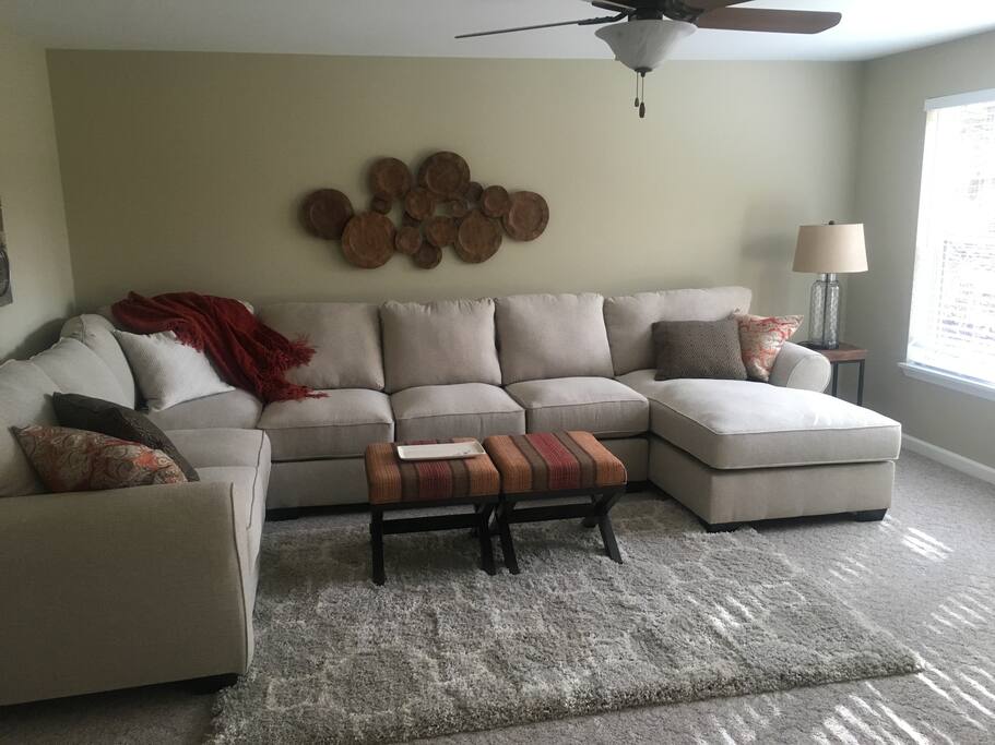 Family room walkout to wooded yard and pond.