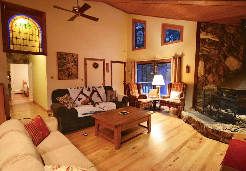 Living area with view of hallway leading to 3 main floor bedrooms