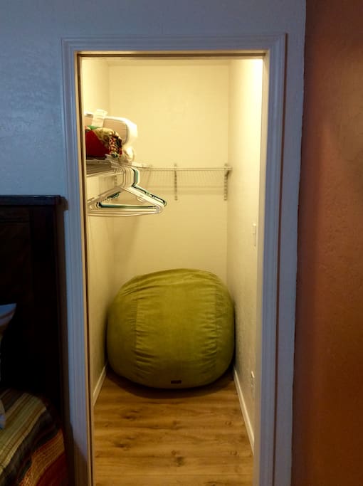 Closet and cordaroy beanbag unfolds into a full size bed.