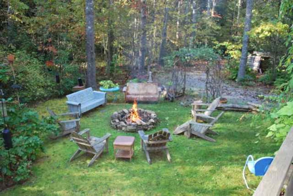 Side moss yard with fire pit. Creek wraps around this area. Heaven!