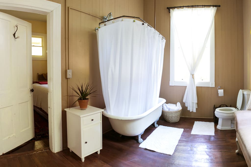 The shared bathroom with private entrance from the bedroom. The clawfoot tub is original to the house.