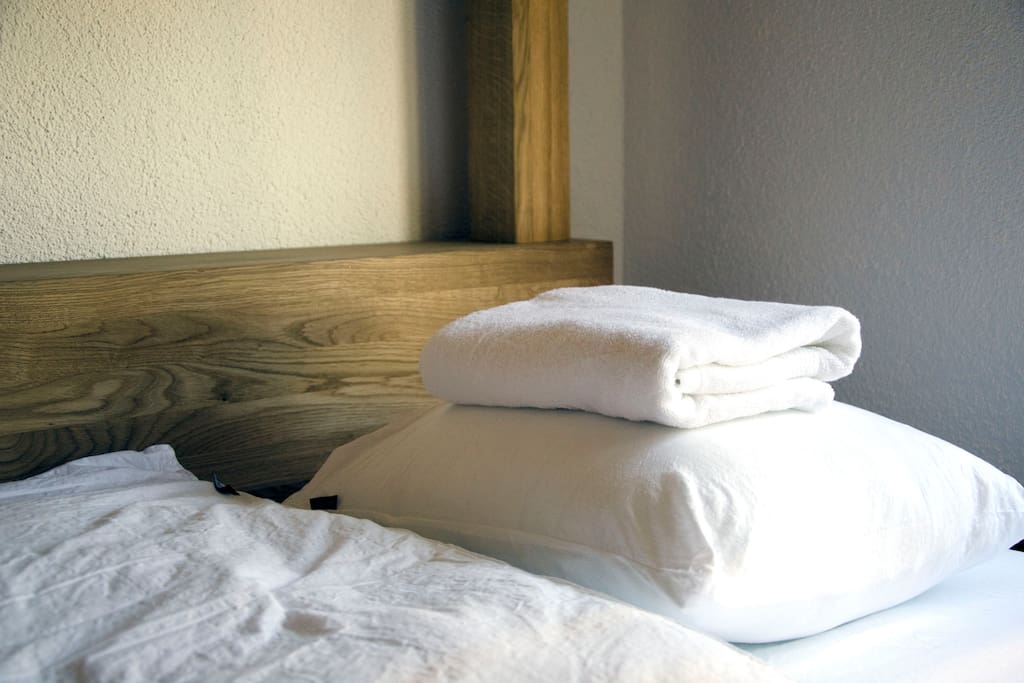 Bed with linen and towel