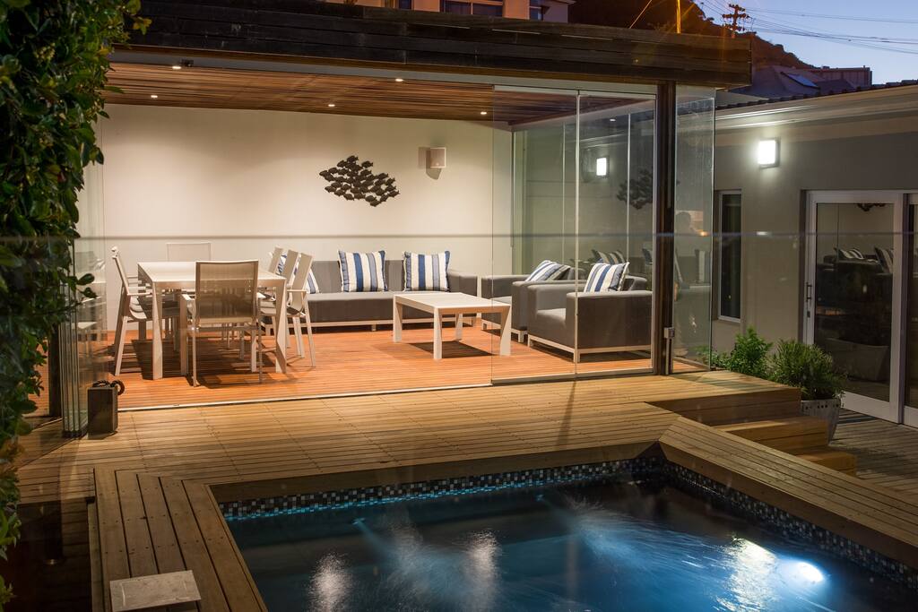 Pool room with built-in barbecue and flowing out to the pool