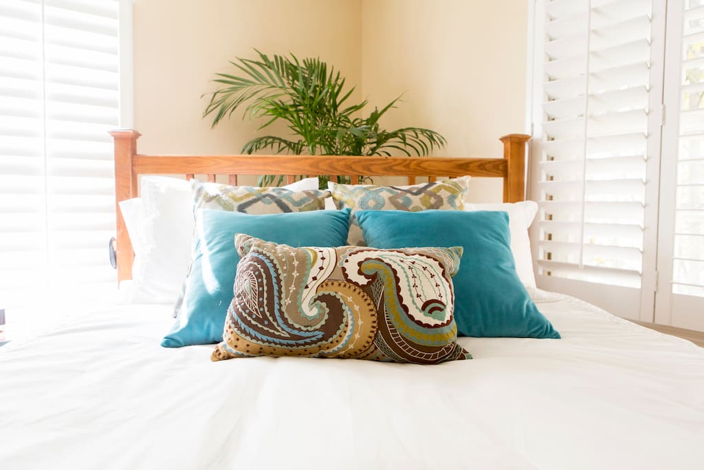 Natural light, plantation shutters and down filled, cotton covered comforter-all ready for you to sink in to.