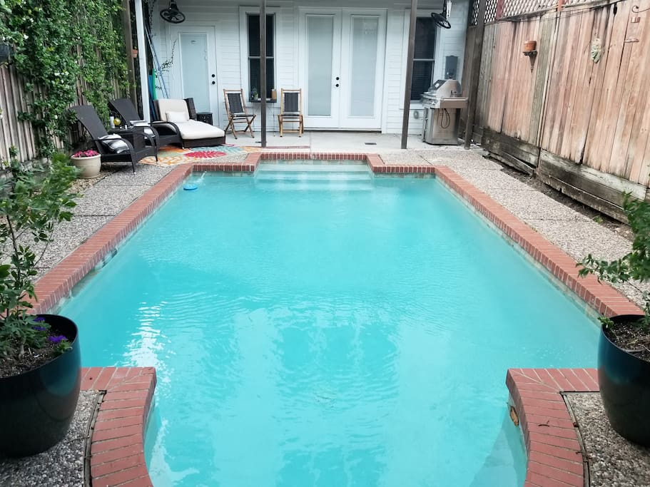 Shaded patio with gas grill and pool.
