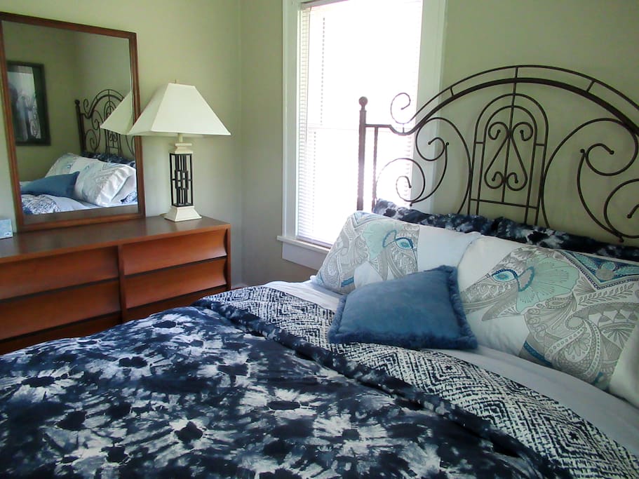 A queen bed in the master bedroom with wall to wall closet.
