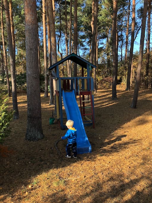 Spielturm mit Rutsche direkt hinter dem Haus