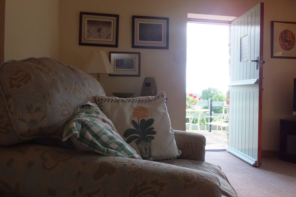 Lounge area with views through the stable door onto the balcony.
