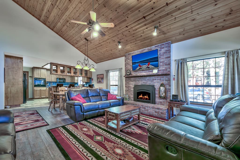 Get comfy on the leather sofas with recliners, feel warmth from the gas fireplace, enjoy the the 60-inch smart TV with cable, Netflix, and more