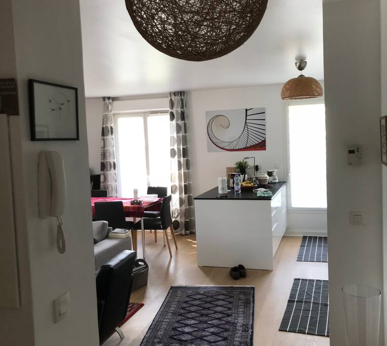 View from the entrance of the apartment through the livingroom and the kitchen