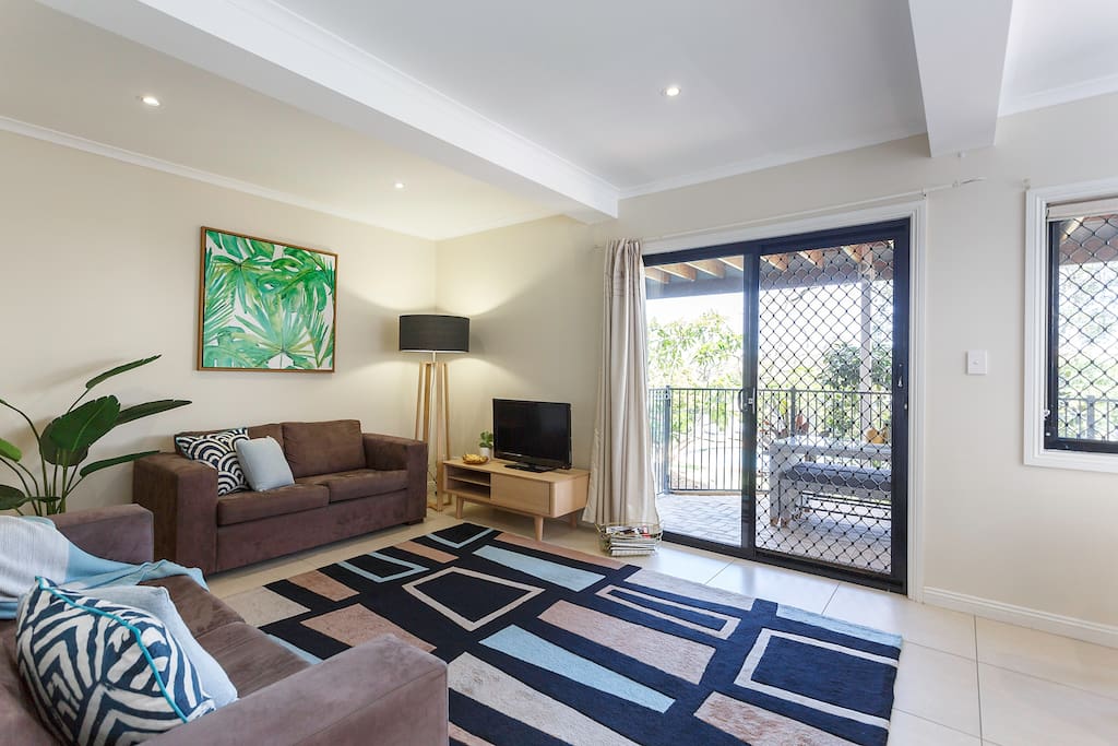 Living area looking out over the pool with BBQ & outdoor setting