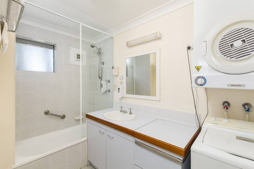 Bathroom including dryer and washer