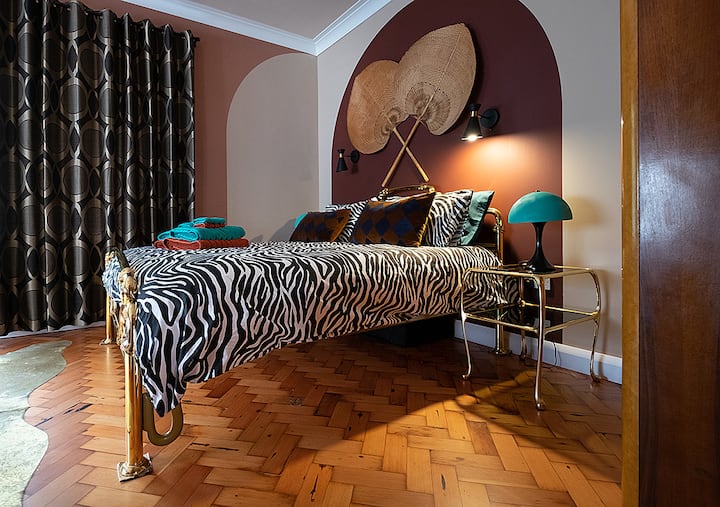 Large master bedroom with king sized bed, separate dressing table, large Art Deco wardrobe and seating area. 