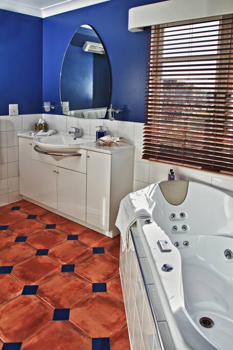 Private spacious bathroom with spa bath and separate shower.