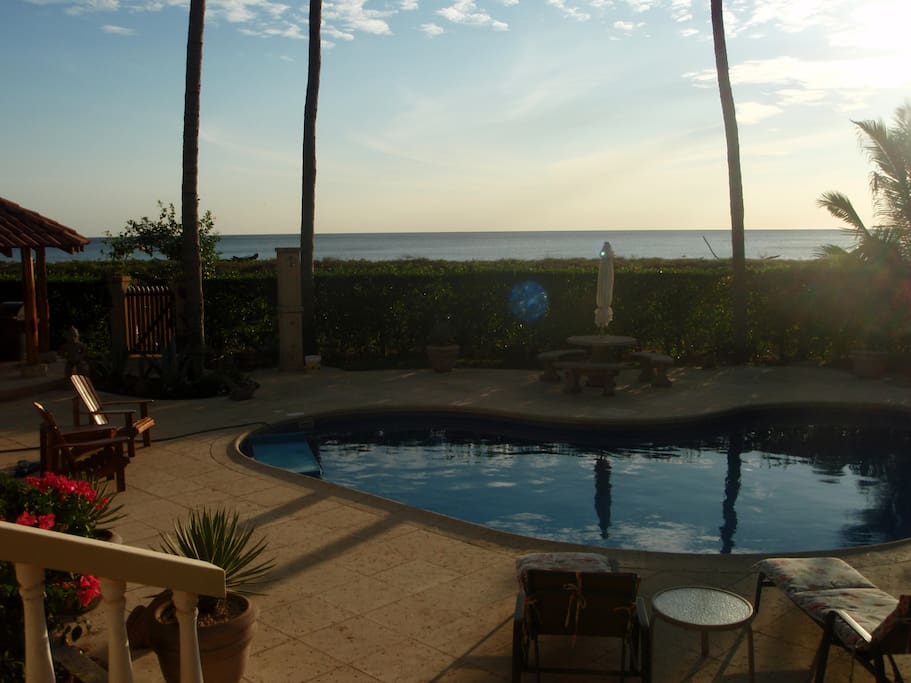 Terrace view to pool and beach beyond the gate