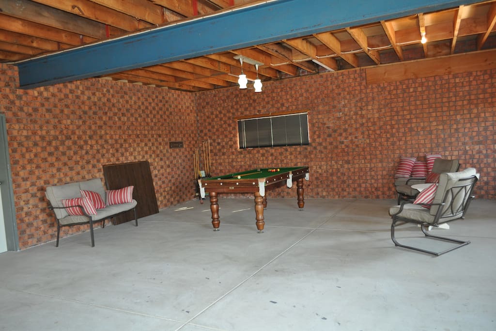 Large garage with pool table and dart board