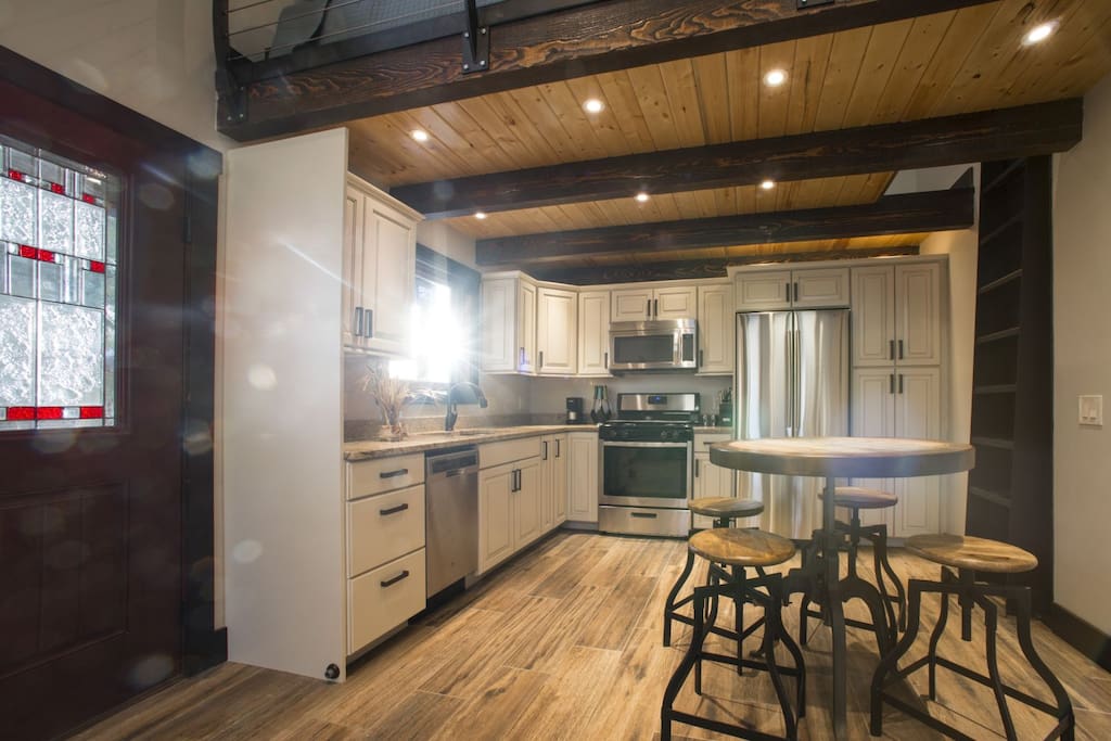 Kitchen with granite, stainless appliances & 100% LED throughout.