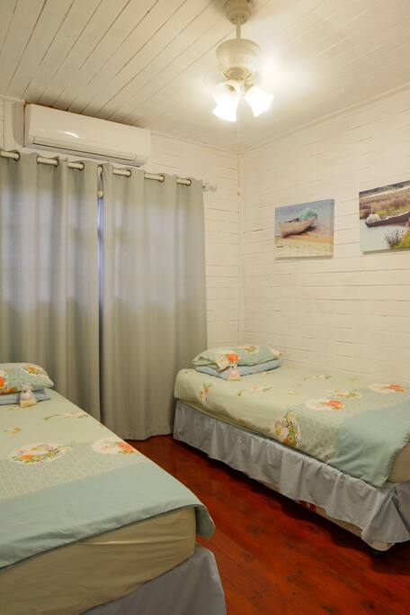 Bedroom furnished with 1 Double Bed or 2 Single Beds. Air Conditioned.