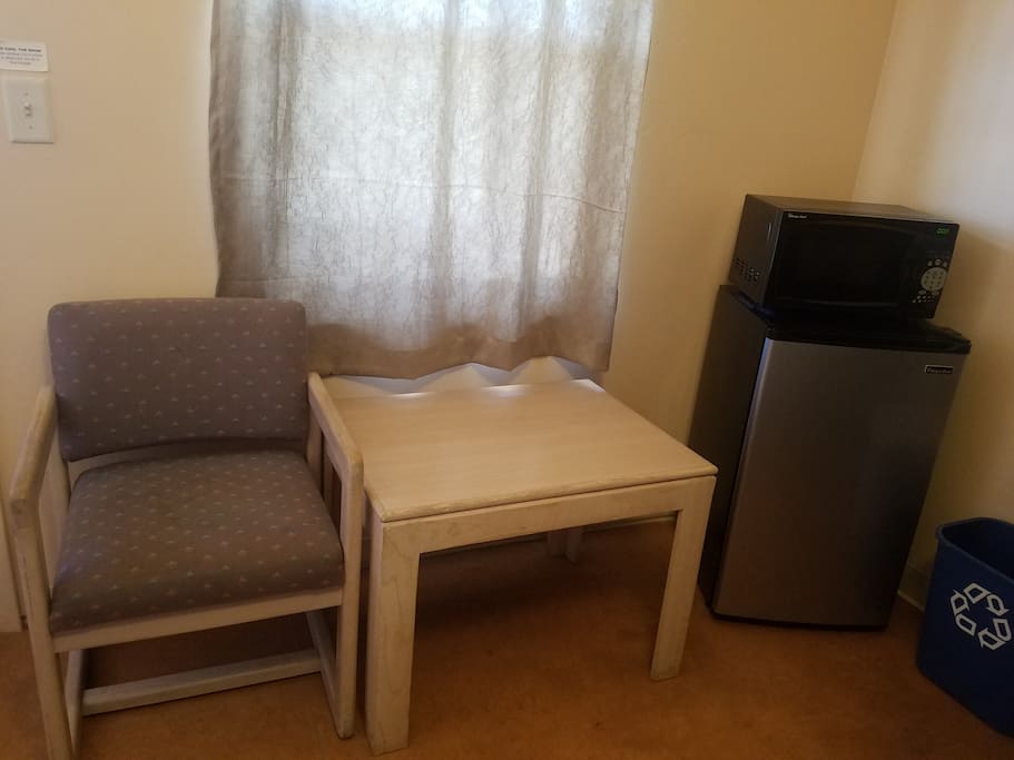 Each cabin style room also includes a microwave, mini-fridge, side table, and chair.