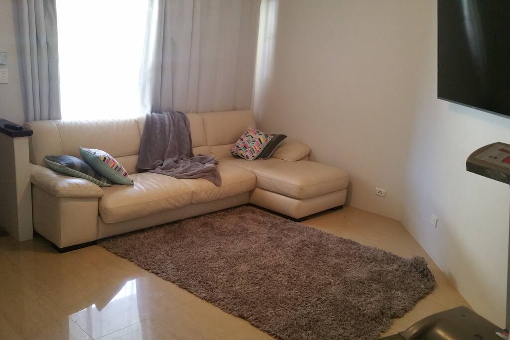 Lounge area with Smart T.V and Treadmill.