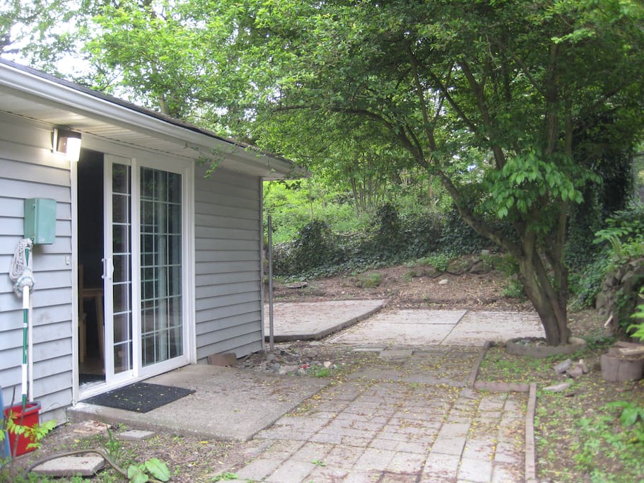 Sliding door leading out to the patio from the dining room. Barbeque and patio table and chairs.