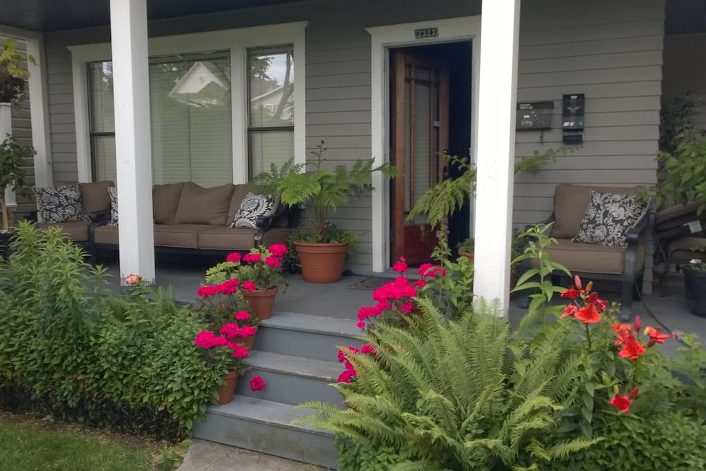 Covered front porch. With outdoor couch and two reading chairs