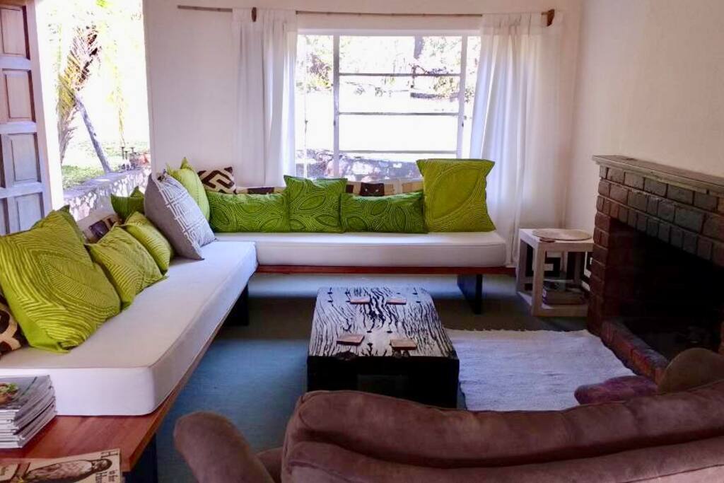 Spacious, airy living area with open log fireplace