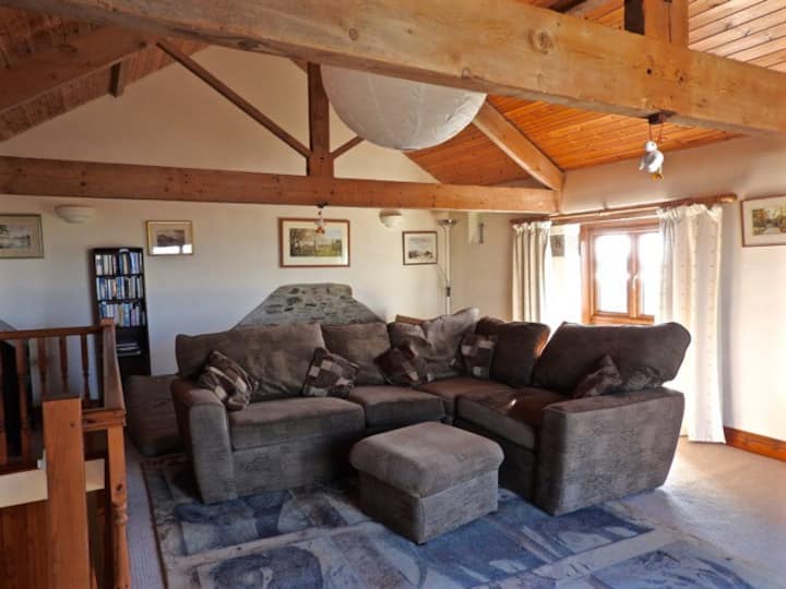 The upstairs lounge room. Very comfy sofa, double futon in the back corner which can be made up on request. A fantastic view of the Cornish countryside from the full length window