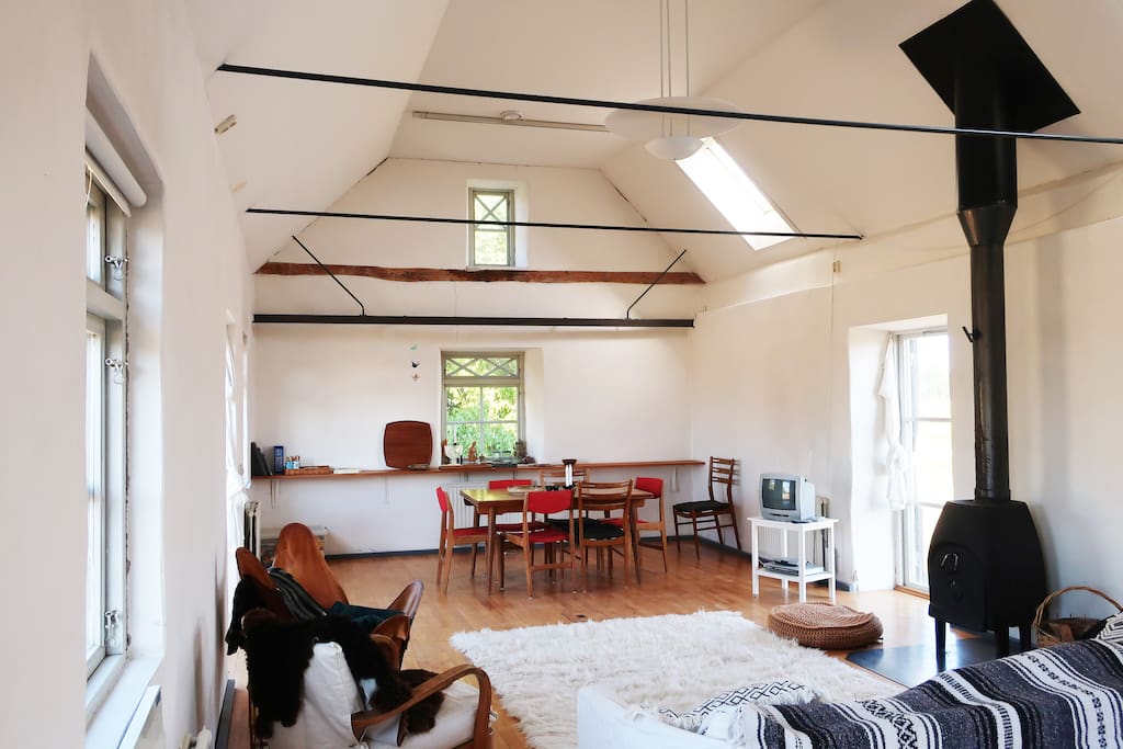 Living room with plenty of natural light and cast iron stove