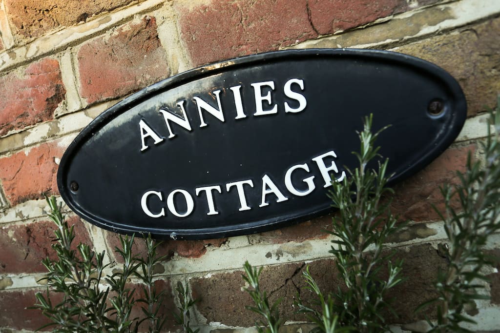 Nameplate outside cottage.