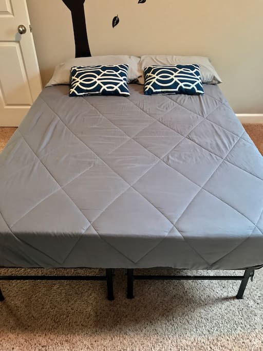 Frontal view of the comfortable full-size bed.