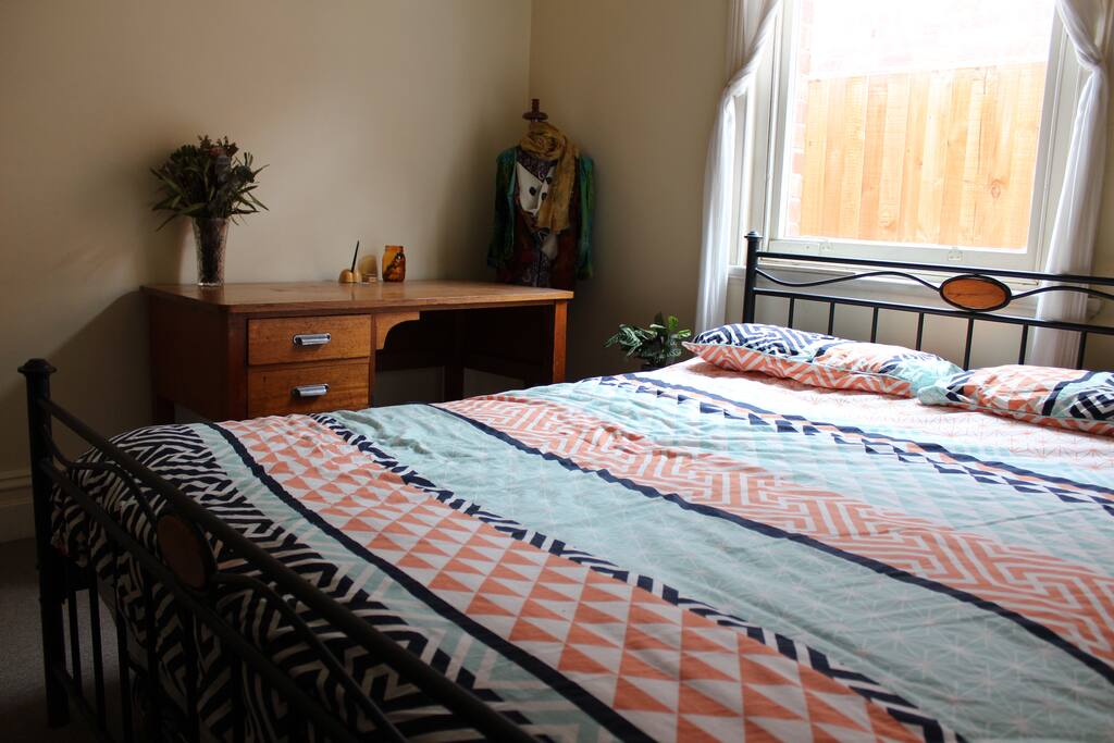 Queen sized bed with desk