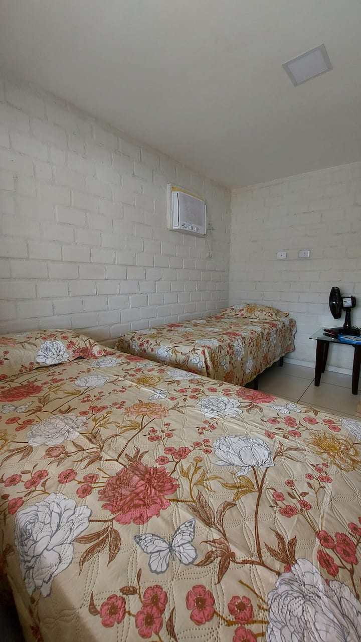 Bedroom 4 (ground floor) - 1 double bed, 1 single bed, dresser, air conditioning and black-out curtain