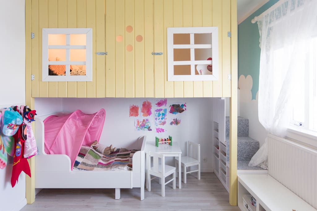 this child room was custom made and has a playhouse for kids.