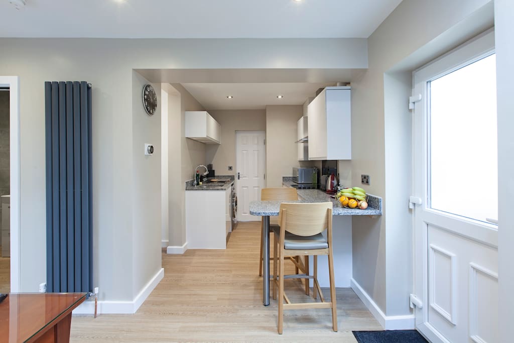 Breakfast bar and open kitchen with washing machine and dryer, fridge freezer