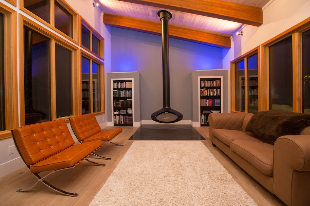 Incredible living room with hanging fireplace and beautiful accent lighting.
