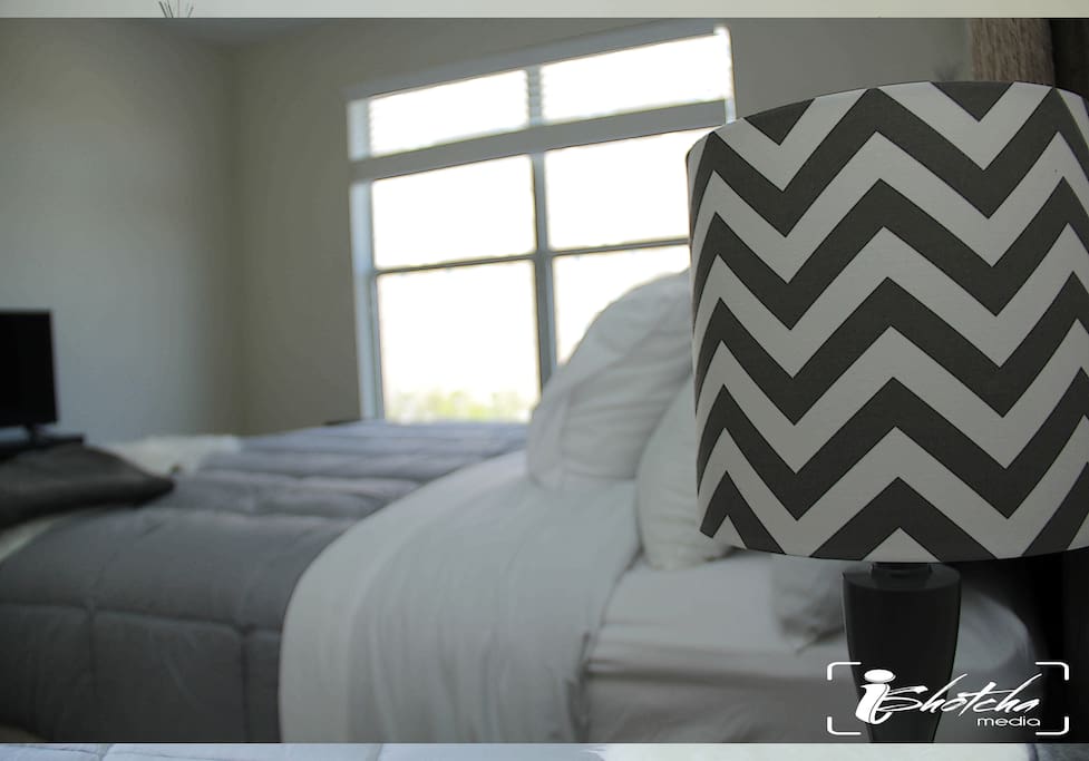 King size bed with smart tv in the bedroom.